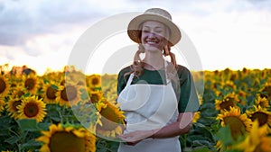 Woman agronomist standing agricultural sunflower field Caucasian female farmer straw hat Portrait agribusiness worker