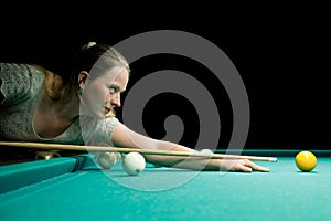 Woman aiming for billiard