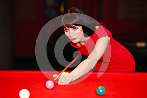 Woman aiming for the billiard table