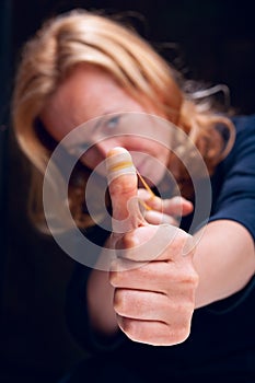 Woman aiming with elastic band