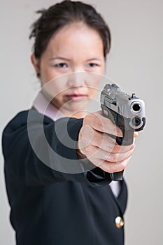 Woman aiming a hand gun