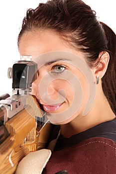 Woman aiming a pneumatic air rifle