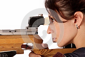 Woman aiming a pneumatic air rifle photo