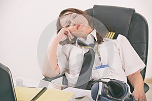 Woman airline pilot sleeping in the office