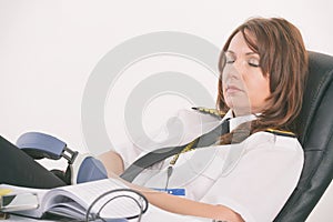 Woman airline pilot sleeping in the office