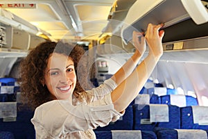 Woman on airplane adds baggage photo