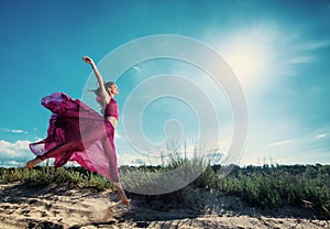 Woman in airy dress running on the beach photo