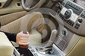 Woman alcoholic with a bottle of booze in the car photo