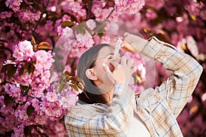 Woman allergic using medical eyes drops, suffering from seasonal allergy at spring