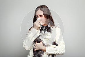 Woman with allergy holding cat photo