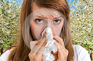 Woman with allergy near flowering trees