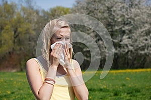 Woman with allergy sneezing photo
