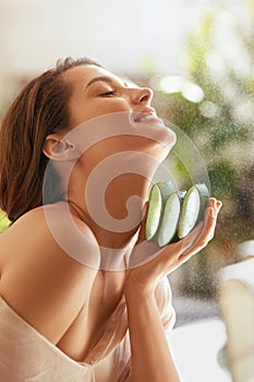 Woman With Aloe Vera. Happy Model Holding Fresh Juicy Slices Of Leaf. Organic Cosmetic For Hydrated Skin.