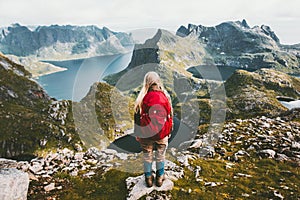 Woman alone with backpack exploring mountains of Norway