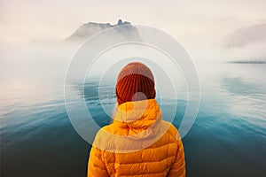 Woman alone looking at foggy cold sea traveling adventure lifestyle photo