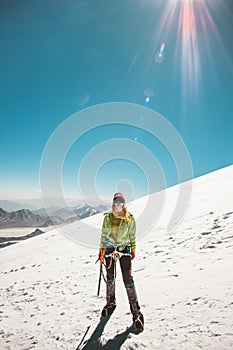 Woman alpinist climbing in high mountains glacier