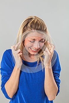 Woman with ambition crossing her fingers for scaring success