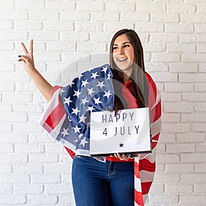 woman with american flag holding lightbox with words Happy 4 July