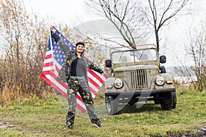 Woman with american flag and military car