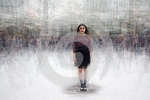 Woman amidst a busy crowd of moving people