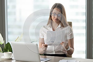 Woman analyzing downward financial indicators