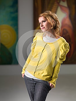 Woman analyzing a painting in an art museum