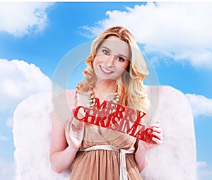 Woman angel with merry christmas sign