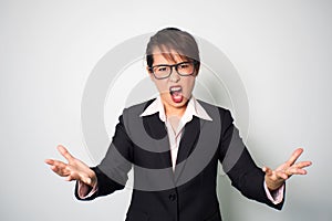 Woman angry. Shouting and holding hands forward. Emotional portrait background.