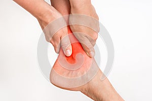 Woman with ankle pain holding her aching leg