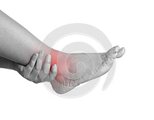 Woman with ankle pain using hand holding leg and massaging painful her