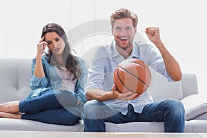 Woman annoyed by her partner watching basketball game