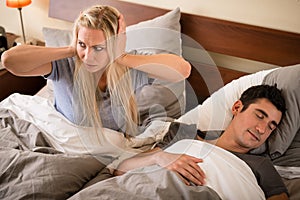 Woman annoyed by the snoring of her partner