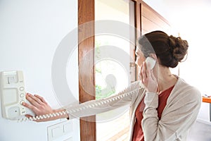 Woman answering door security phone