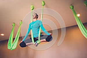 Woman on antigravity yoga exercise