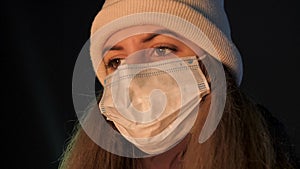 Woman With Antiviral Mask On Her Face Looking Hopefully At Fire In Winter Night