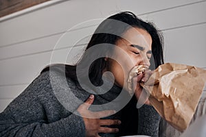 Woman, anxiety and stress paper bag breathing of a woman with mental health problem or crisis. Hyperventilate, panic or