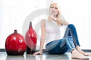 Woman on apartment floor having idea