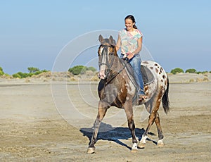 Woman and appaloosa horse