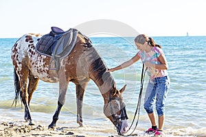 woman and appaloosa horse