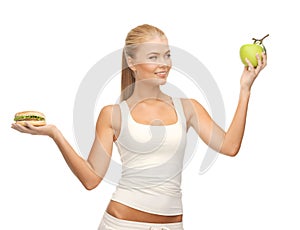 Woman with apple and hamburger