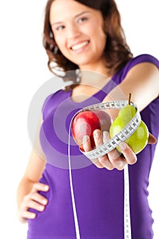 Woman with apple, pear and measuring tape