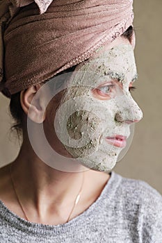 The woman applied green clay to her face as part of her regular cosmetic procedures