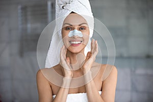 Woman apply cleansing pore nose strips smiles looks at camera photo