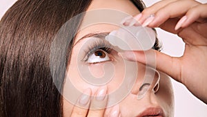 Woman apply eye drops. Girl glaucoma treatment photo