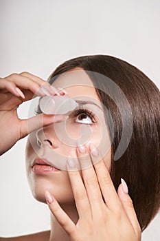 Woman apply eye drops. Girl glaucoma treatment