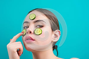 Woman apply facial mask isolated over blue studio background. Spa, cosmetic mask. Beautiful woman with clay facial mask