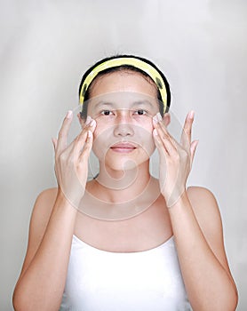 Woman applying aloe vera cream to face