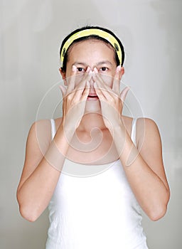 Woman applying aloe vera cream to face