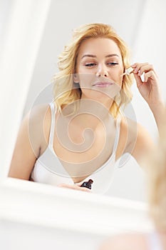 Woman applying anti-aging moisturizer