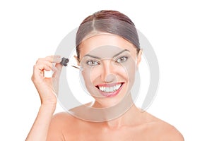 Woman applying anti mimic wrinkles eye face serum essential oil smiling